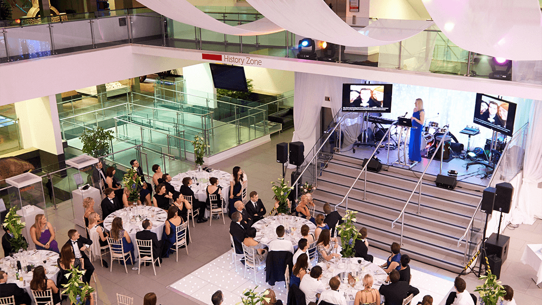 Ulster Museum Atrium with tables for wedding or corporate hire
