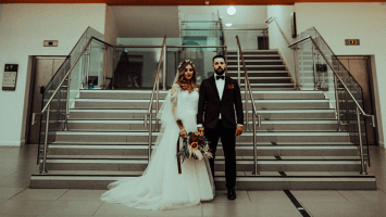 Bride and groom at Atrium staircase