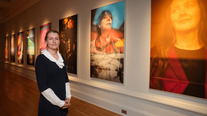World-renowned, Belfast-born photographer Hannah Starkey pictured inside the gallery at Ulster Museum where large, colourful portraits of women who were influential to peace building in Northern Ireland are on display in a new exhibition.