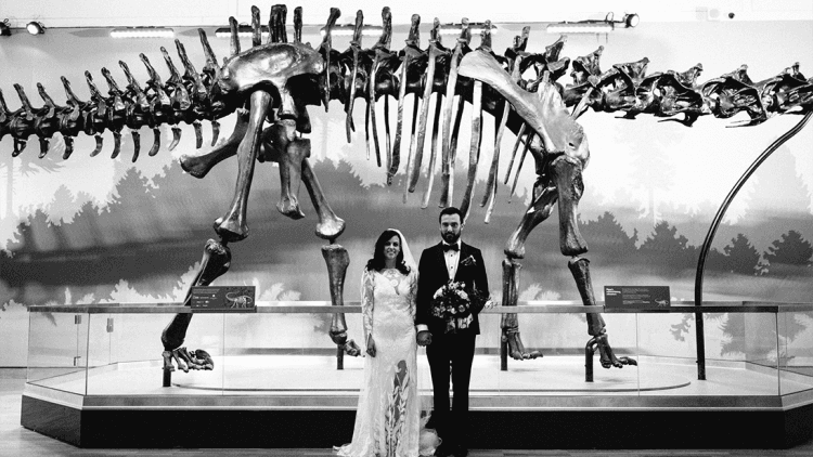 Bride and groom with dinosaur