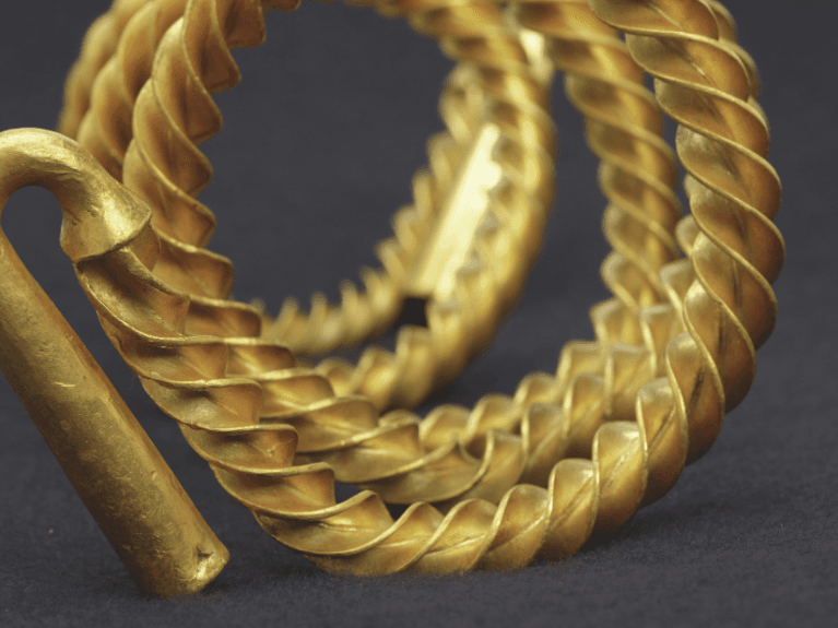 close up of gold rings and a gold hook