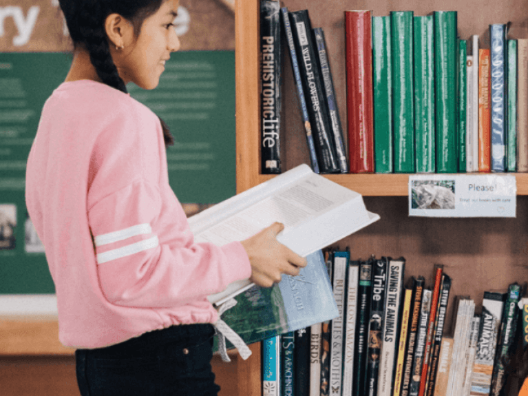 a girl looking at books 